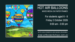 Colourful mixed-media hot-air balloons floating over a painted landscape in a framed children’s artwork.
